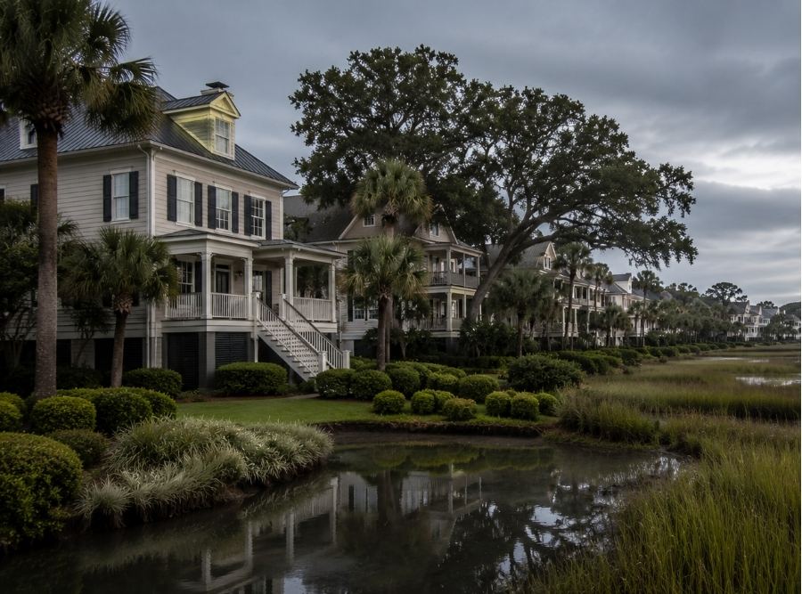 Luxury coastal neighborhood on Hilton Head Island, South Carolina with subtle flood-zone and coastal-risk atmosphere during calm overcast weather