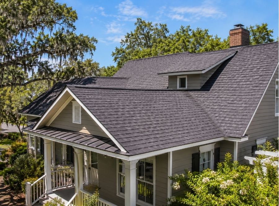 Lowcountry home in Beaufort, SC with a newer wind-resistant roof, surrounded by mature live oak trees in a coastal residential neighborhood.