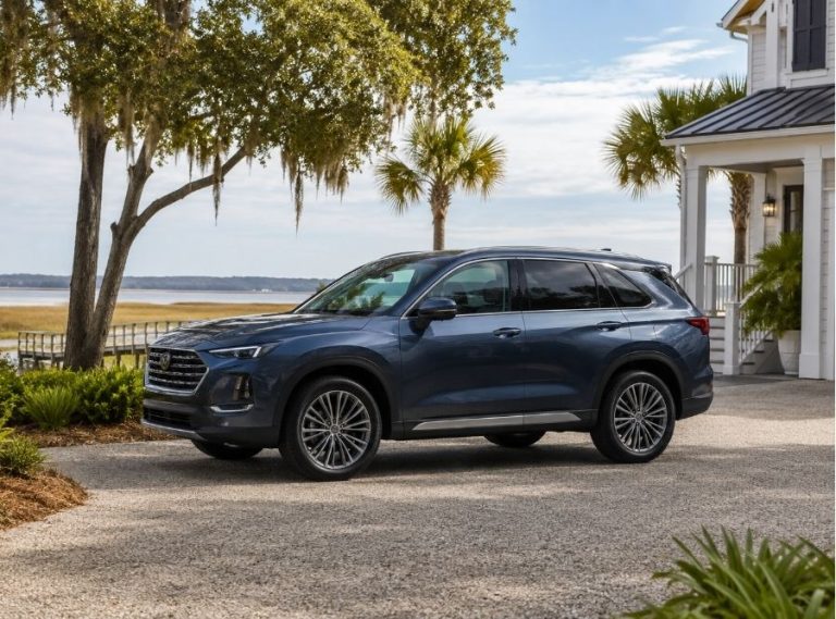 Late-model SUV parked in the driveway of a coastal Hilton Head Island home, surrounded by live oaks, palm trees, and marsh views under a calm Lowcountry sky.